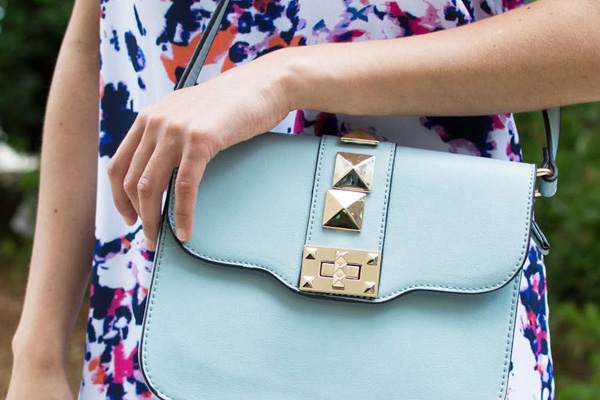 girl holding blue handbag